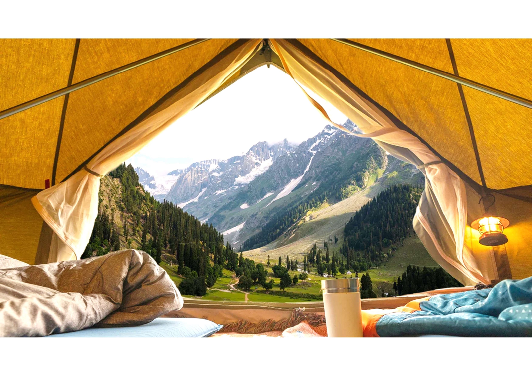 A view from a tent with mountains and trees.