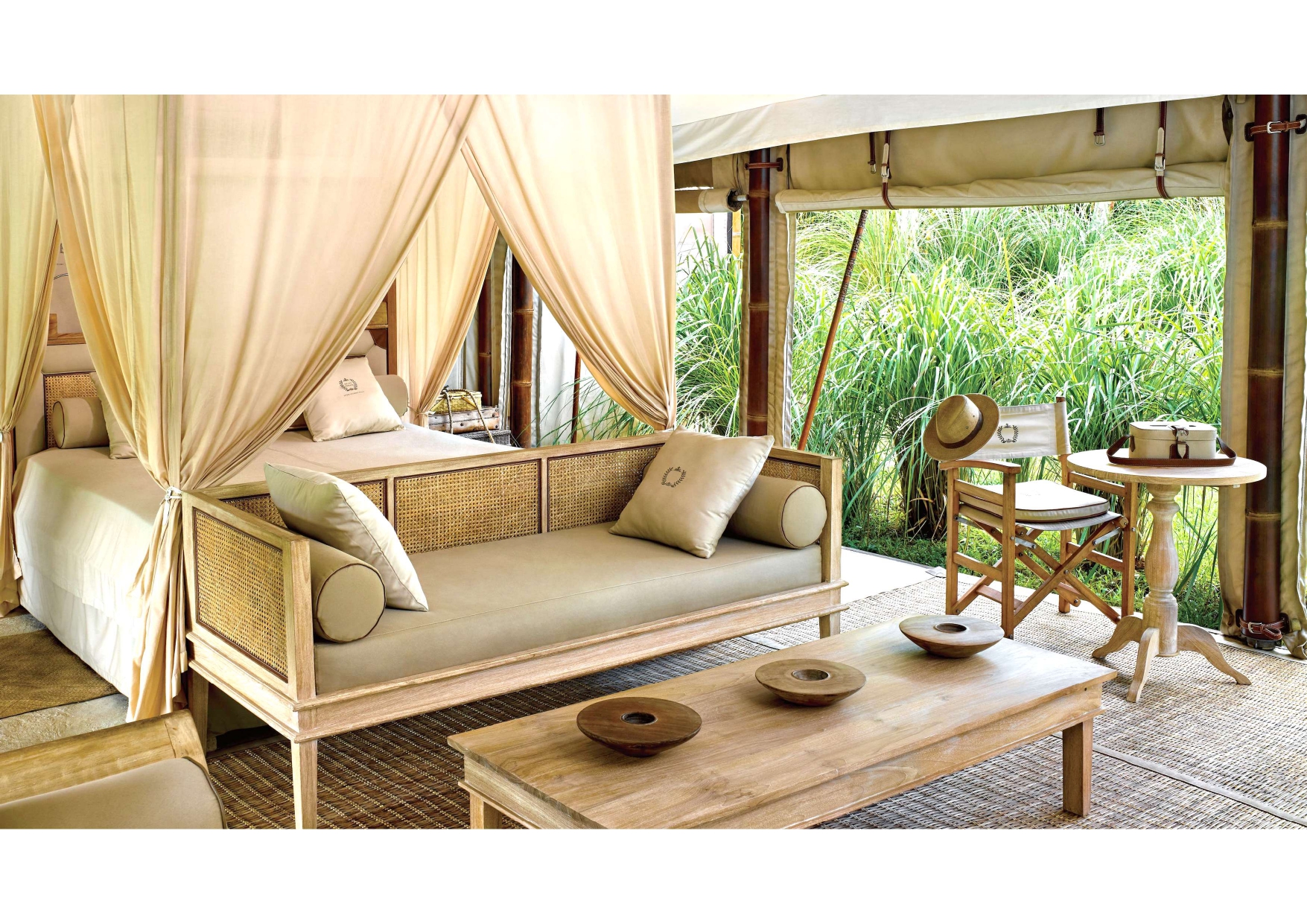 A room with a canopy bed and a couch.