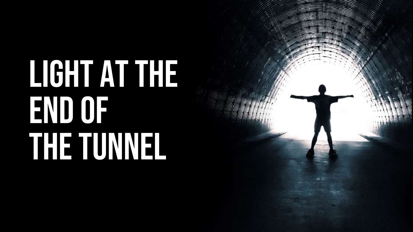 A person stands with outstretched arms at the bright exit of a dark tunnel, with the phrase "Light at the end of the tunnel" written on the left.