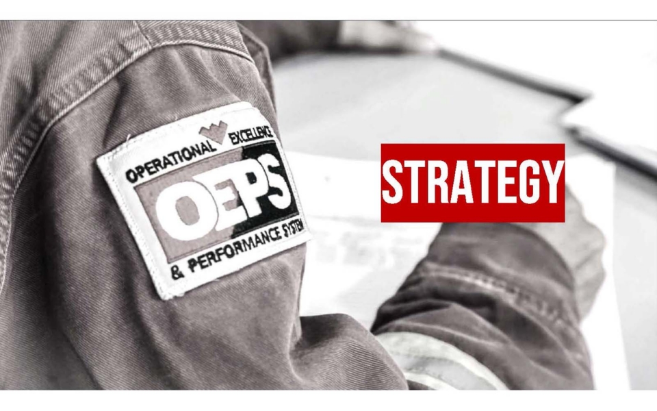 Close-up of a person wearing a jacket with an "OEPS" patch; the word "STRATEGY" appears in bold red text on the right.