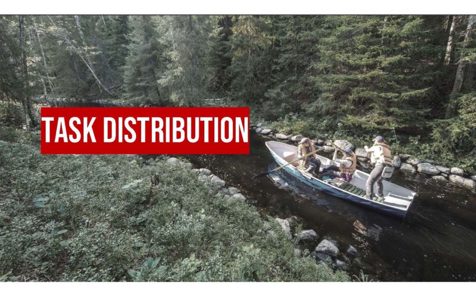 Three people paddle a canoe along a narrow, tree-lined river. The words "TASK DISTRIBUTION" appear in large red and white text across the image.