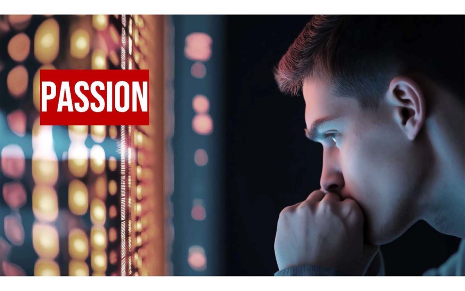 A young man looks thoughtfully at a display of illuminated circular patterns; the word "PASSION" appears in bold white text on a red background.